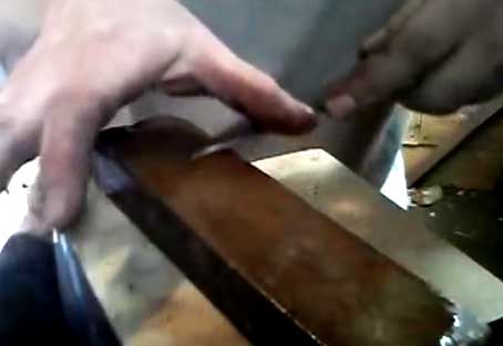 using an oil stone to sharpen a small knife